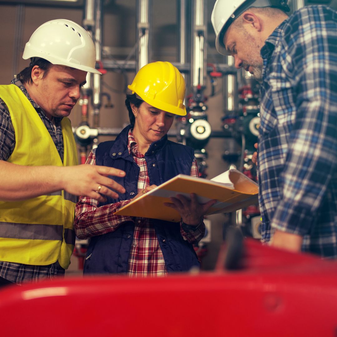 Construction workers reading binder
