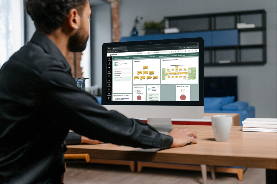 Man using a computer with a productivity software interface in a home office setting.