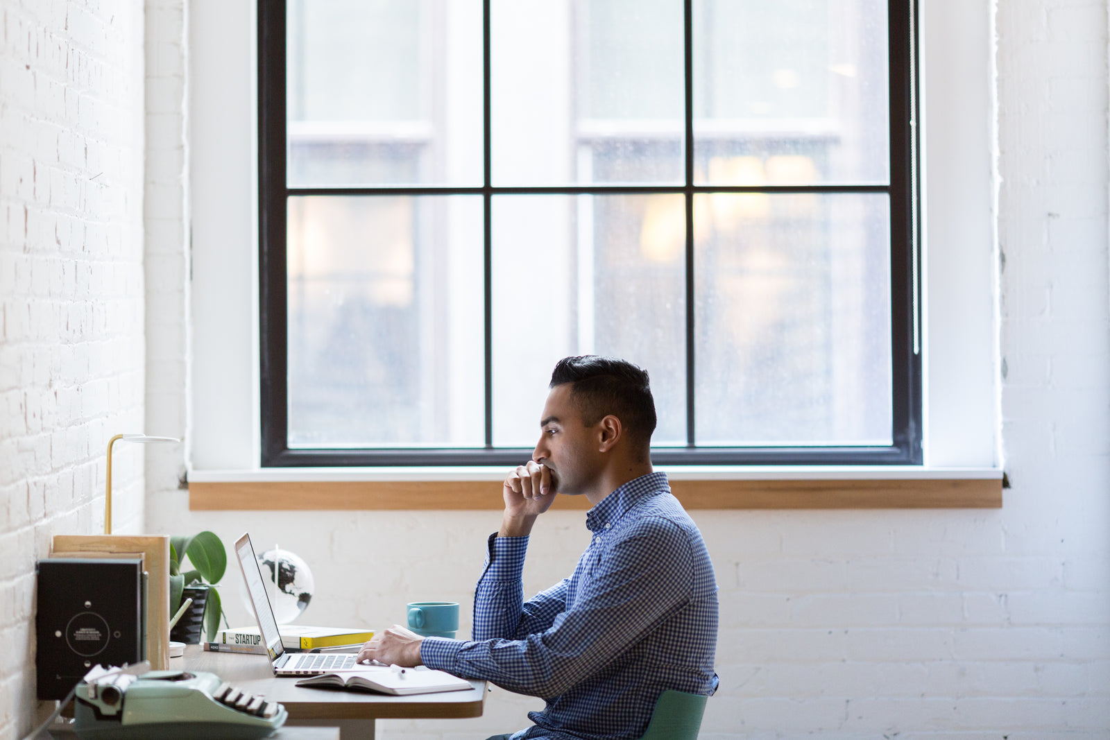 Person thinking at their desk