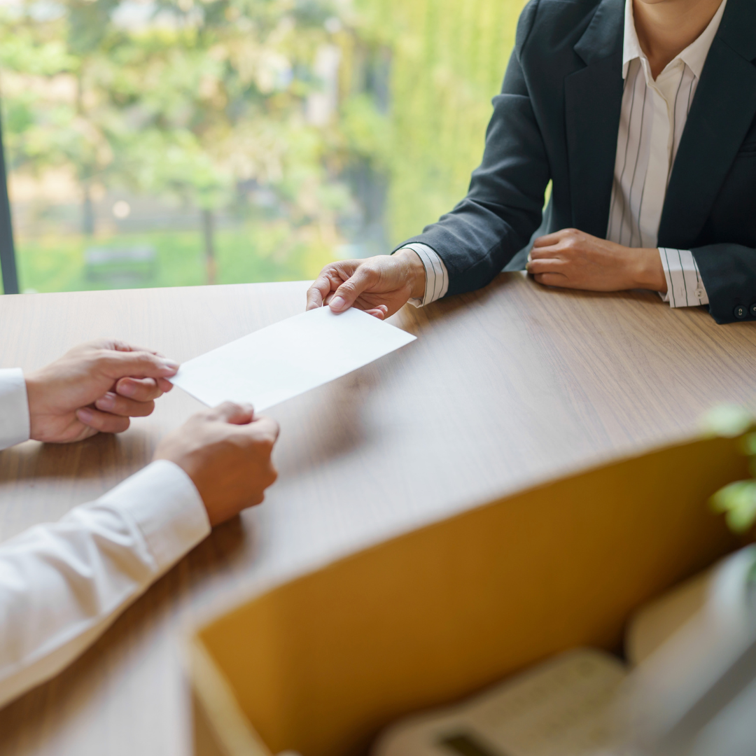 Executives handing paper to eachother