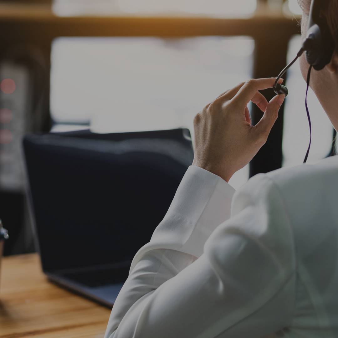 Call center worker talking and using a computer