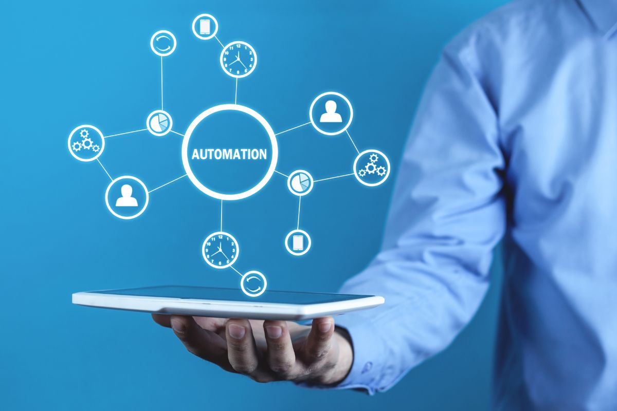 A person holding an ipad with a hologram of automation and process connections being displayed