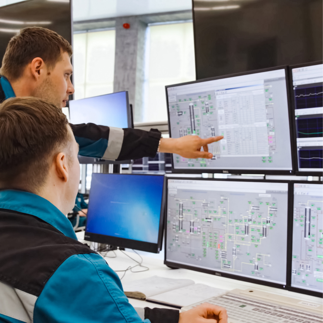 people looking at workflows on multiple computer screens