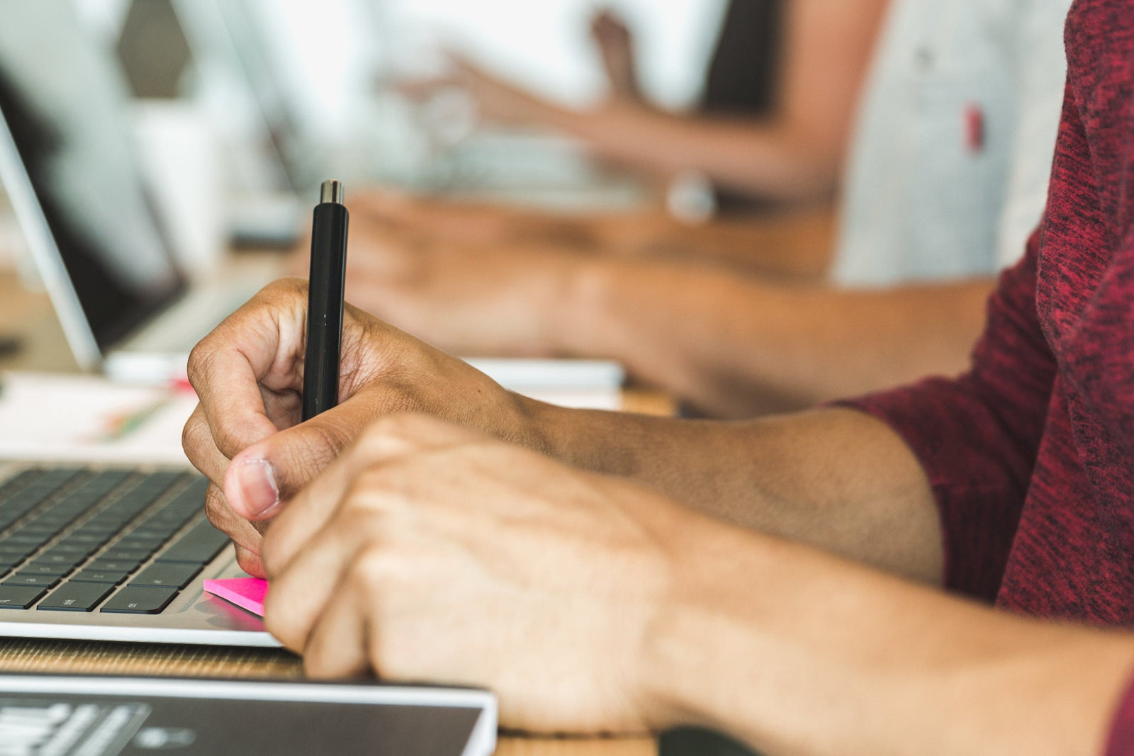 man writing in postit notes at meeting