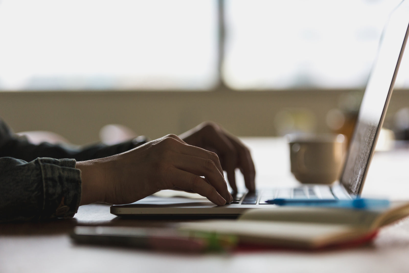 Hands typing on computer