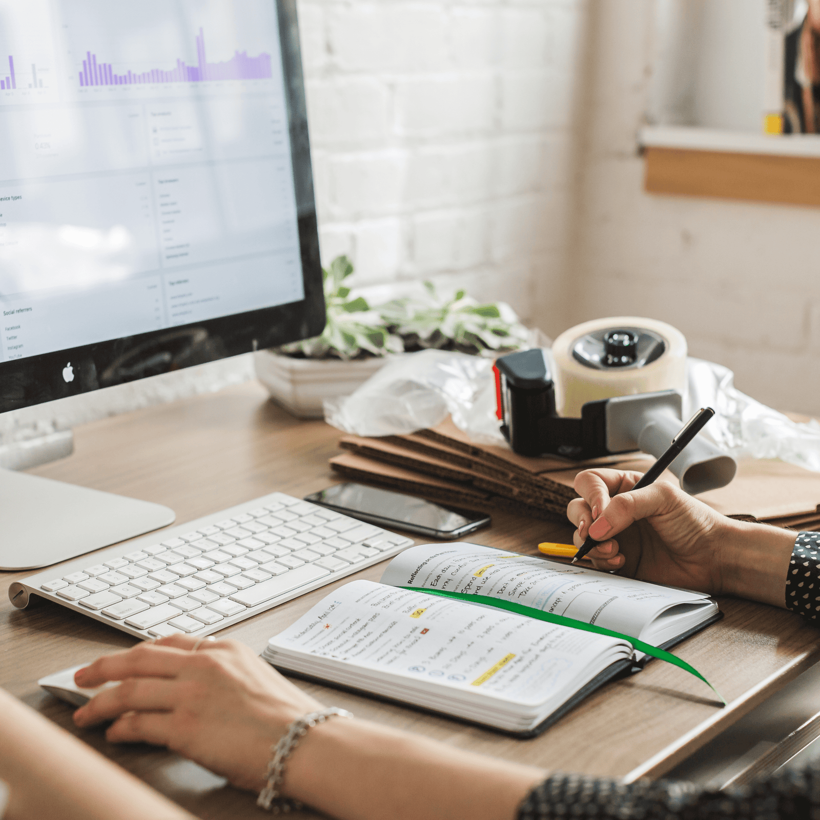 Person talking notes at computer